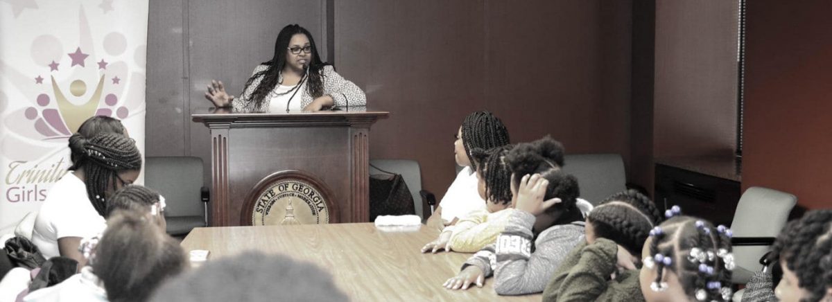 woman speaking in front of the children